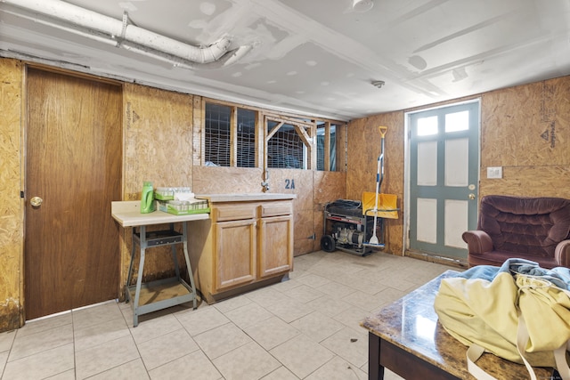 interior space with light countertops and light tile patterned flooring