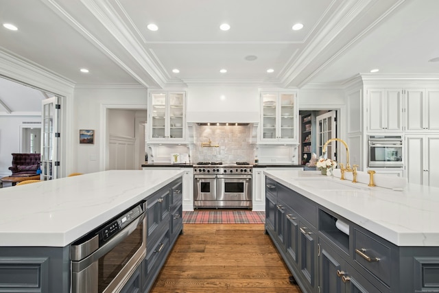 358 Lukes Wood Rd, New Canaan, CT 06840 - kitchen featuring a large island, stainless steel appliances, a sink, white cabinetry, and ornamental molding