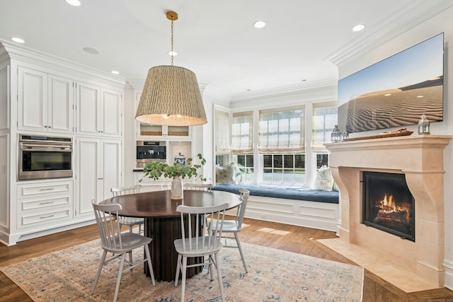 358 Lukes Wood Rd, New Canaan, CT 06840 - dining room with crown molding, wood finished floors, a fireplace with flush hearth, and recessed lighting