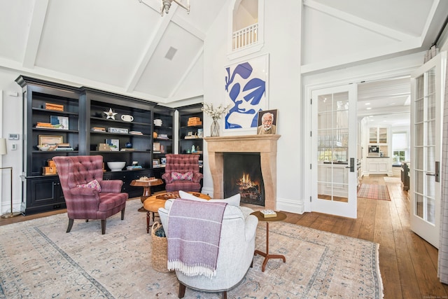 358 Lukes Wood Rd, New Canaan, CT 06840 - living area with wood-type flooring, a premium fireplace, beamed ceiling, and high vaulted ceiling