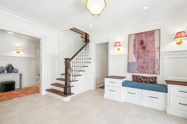 358 Lukes Wood Rd, New Canaan, CT 06840 - mudroom with a decorative wall, wainscoting, ornamental molding, and light tile patterned floors