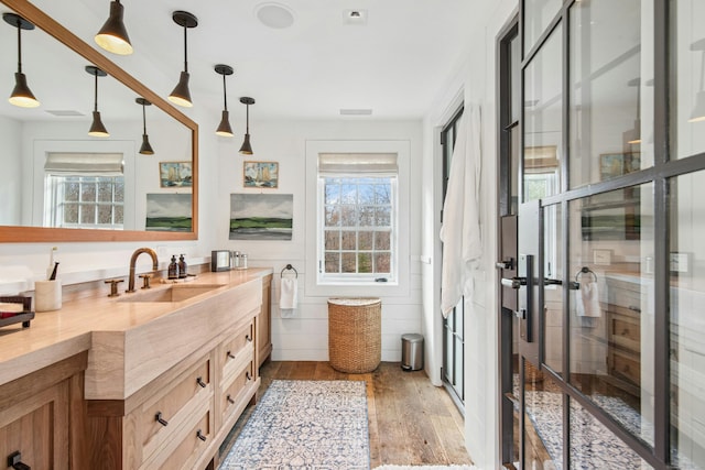 358 Lukes Wood Rd, New Canaan, CT 06840 - bathroom with wood finished floors, plenty of natural light, and vanity