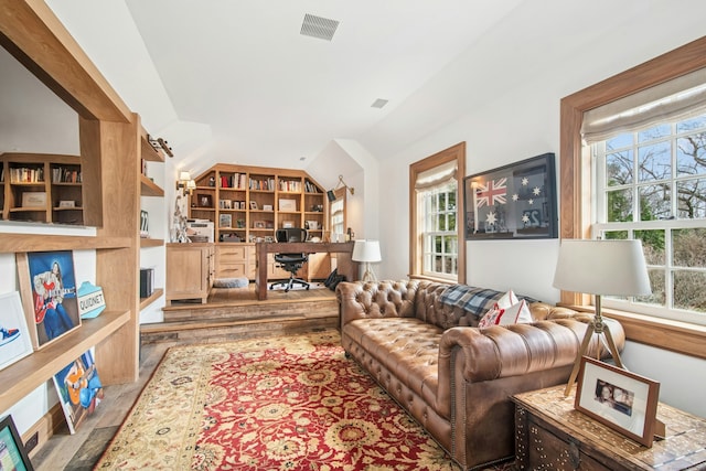 358 Lukes Wood Rd, New Canaan, CT 06840 - living room with plenty of natural light, an office area, wood finished floors, vaulted ceiling, and built in shelves