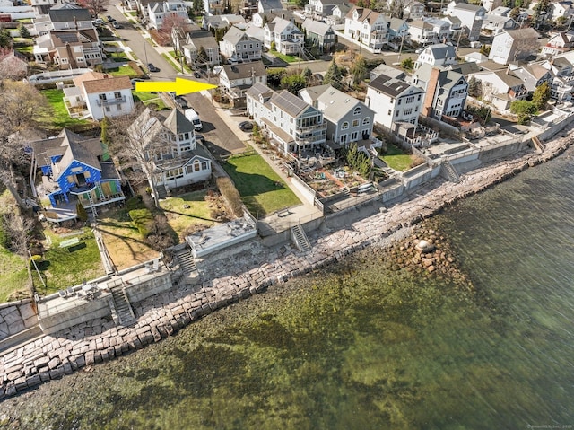 drone / aerial view with a residential view and a water view