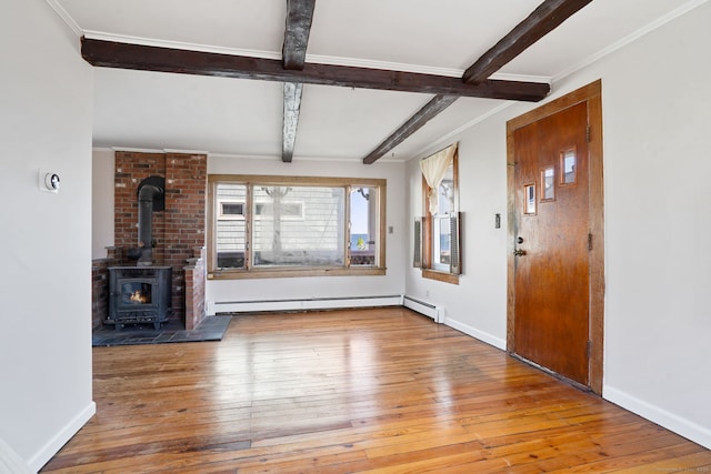 unfurnished living room with hardwood / wood-style flooring, beam ceiling, and a baseboard radiator