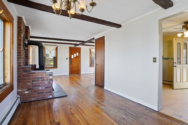 unfurnished living room featuring beam ceiling, hardwood / wood-style flooring, baseboard heating, baseboards, and ornamental molding
