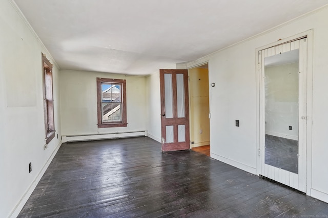 empty room with hardwood / wood-style flooring, ornamental molding, and a baseboard radiator