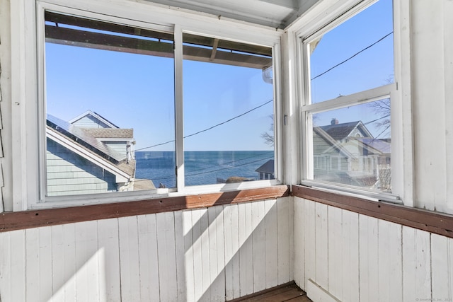 unfurnished sunroom with a water view