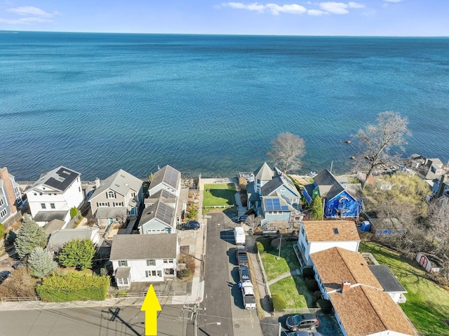 drone / aerial view featuring a water view and a residential view