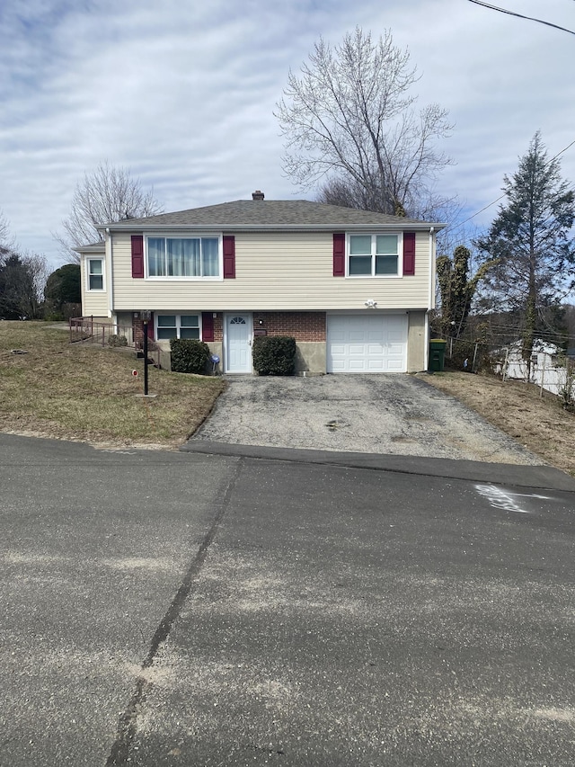 20 Nina Ct, Waterbury, CT 06704 - view of front facade featuring driveway and an attached garage