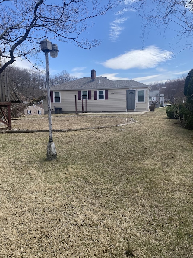 20 Nina Ct, Waterbury, CT 06704 - back of house with a lawn, a chimney, and a shingled roof