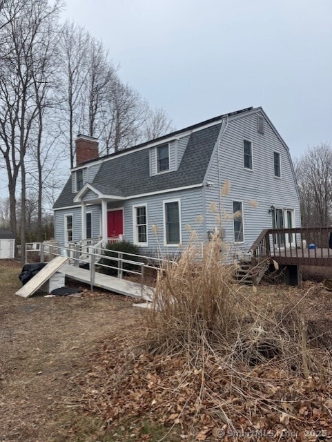 38 High St, Middlefield, CT 06455 - rear view of property with a shingled roof, a chimney, a gambrel roof, and a deck