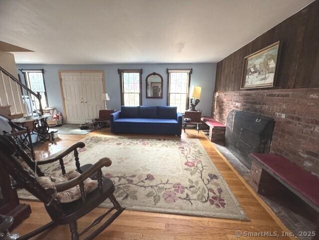 38 High St, Middlefield, CT 06455 - living room with wood walls, stairway, a wood stove, and wood finished floors