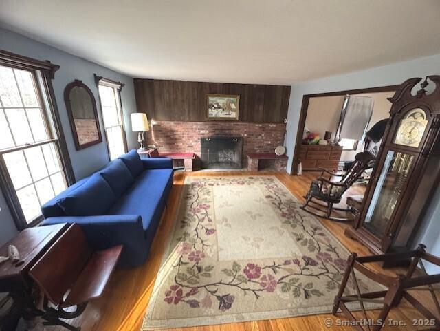 38 High St, Middlefield, CT 06455 - living area featuring a fireplace and wood finished floors