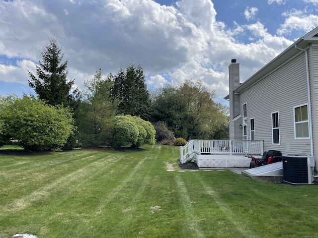 view of yard featuring a deck and central AC