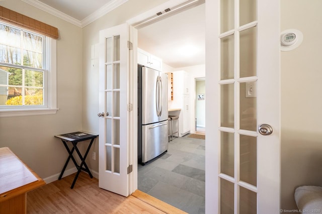 hall with crown molding and baseboards