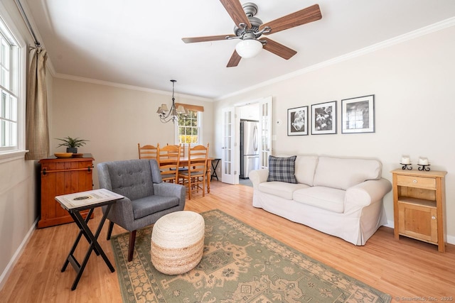 living area featuring light wood-type flooring, baseboards, and ornamental molding