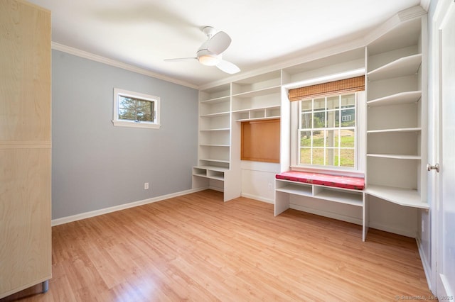 interior space featuring a healthy amount of sunlight, wood finished floors, and crown molding