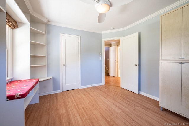 unfurnished bedroom featuring crown molding, light wood finished floors, and baseboards