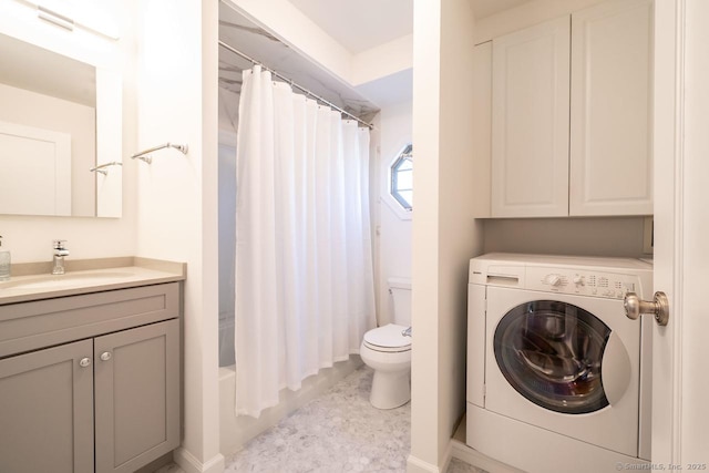 full bath with toilet, vanity, and washer / clothes dryer