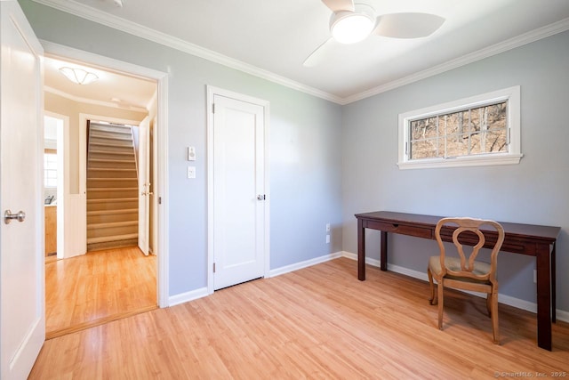 office space featuring light wood-type flooring, ornamental molding, baseboards, and ceiling fan