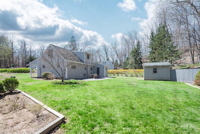 view of yard featuring an outdoor structure, fence, a patio, and a storage shed
