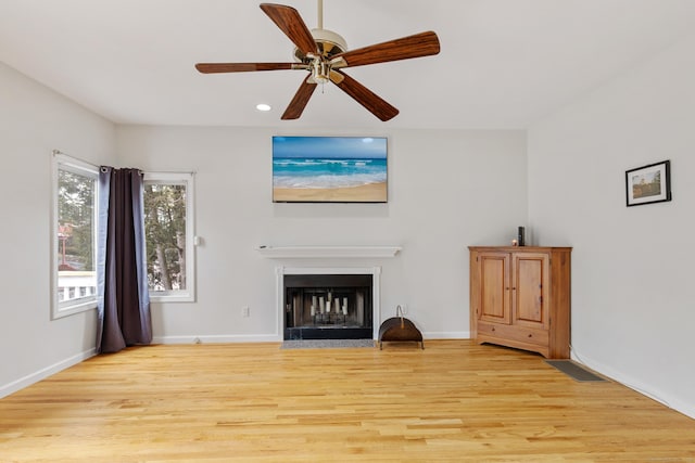 18 Catalpa St, Norwalk, CT 06851 - unfurnished living room featuring visible vents, baseboards, ceiling fan, a fireplace with flush hearth, and light wood-style flooring
