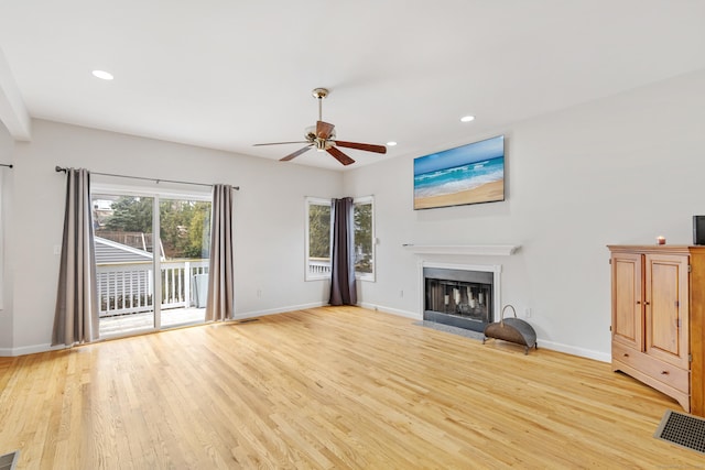 18 Catalpa St, Norwalk, CT 06851 - unfurnished living room with ceiling fan, light wood-style floors, and baseboards