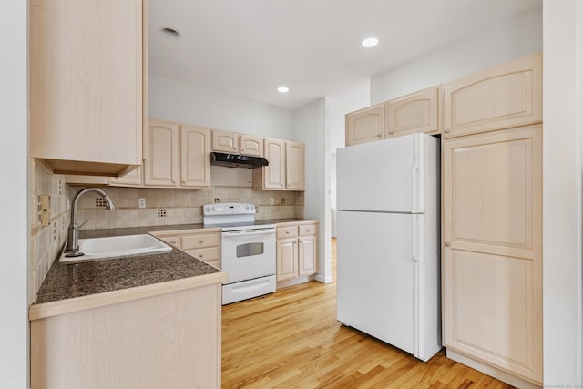 18 Catalpa St, Norwalk, CT 06851 - kitchen with a sink, white appliances, under cabinet range hood, light wood-style flooring, and decorative backsplash
