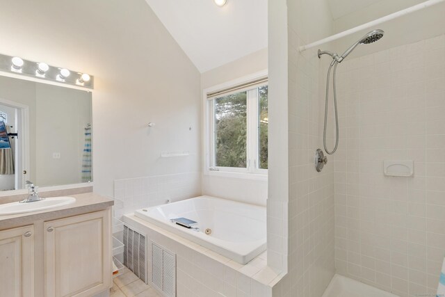 18 Catalpa St, Norwalk, CT 06851 - full bath with a jetted tub, vanity, vaulted ceiling, tile patterned floors, and tiled shower