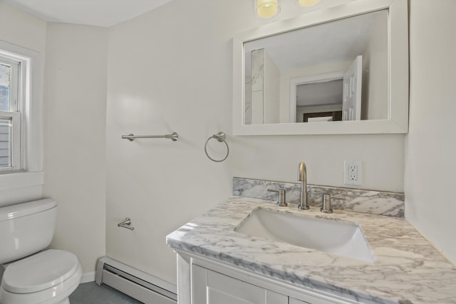 bathroom with baseboard heating, vanity, and toilet