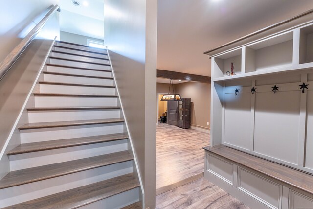 stairway featuring wood finished floors