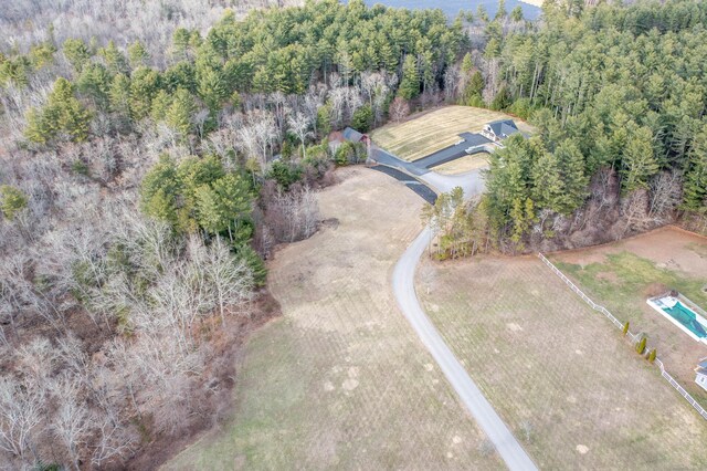 drone / aerial view featuring a wooded view