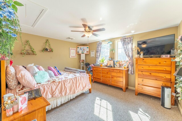bedroom featuring visible vents, light colored carpet, attic access, and ceiling fan