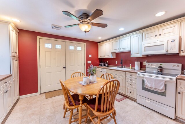 kitchen featuring ceiling fan, white appliances, visible vents, recessed lighting, and a sink