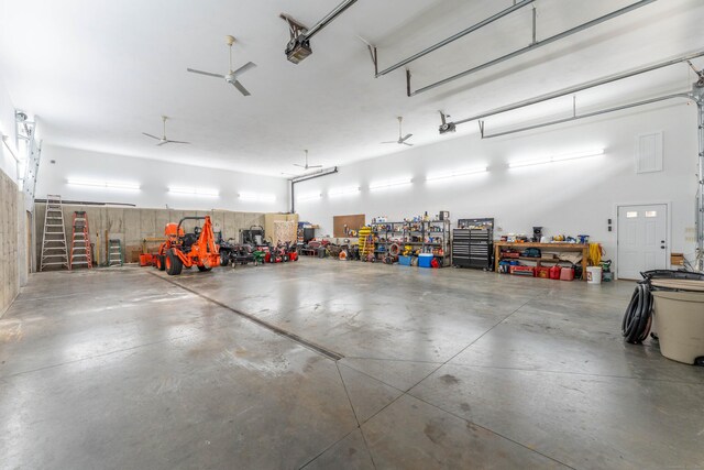 garage with a workshop area and a garage door opener