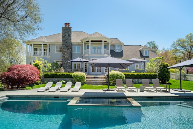 355 Greens Farms Rd, Westport, CT 06880 - back of property featuring a patio area, an outdoor pool, and a balcony