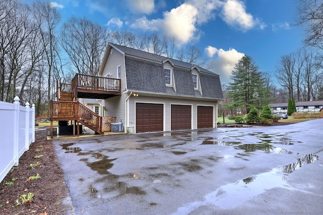 110 Far Mill Dr, Stratford, CT 06614 - view of side of property with a shingled roof, an attached garage, stairs, a gambrel roof, and driveway