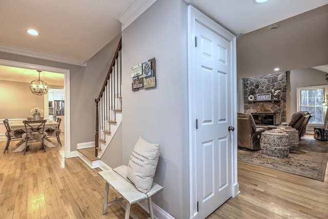 110 Far Mill Dr, Stratford, CT 06614 - hall with an inviting chandelier, ornamental molding, stairs, light wood finished floors, and baseboards