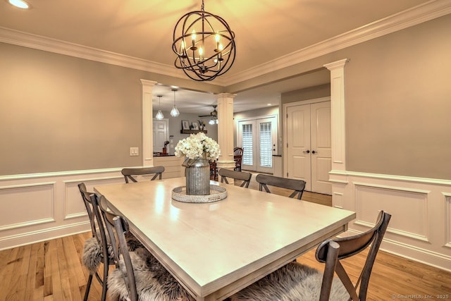 110 Far Mill Dr, Stratford, CT 06614 - dining room with light wood-style floors, a decorative wall, decorative columns, ornamental molding, and a chandelier
