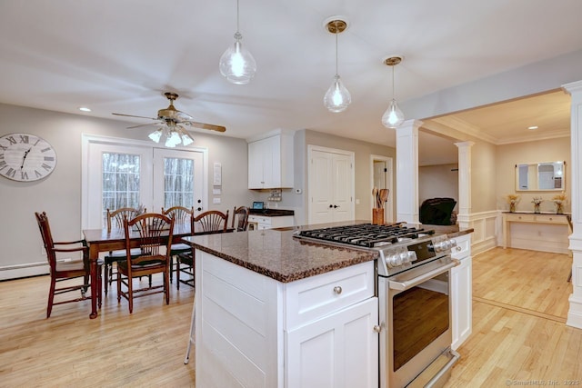 110 Far Mill Dr, Stratford, CT 06614 - kitchen featuring decorative columns, stainless steel stove, light wood-style flooring, and ceiling fan