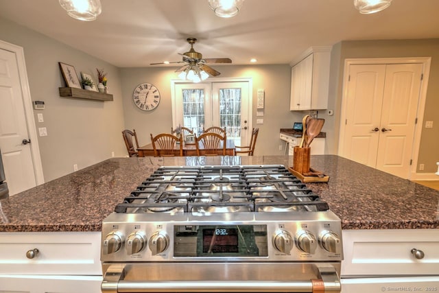 110 Far Mill Dr, Stratford, CT 06614 - kitchen featuring dark stone countertops, ceiling fan, white cabinetry, recessed lighting, and stainless steel gas range oven