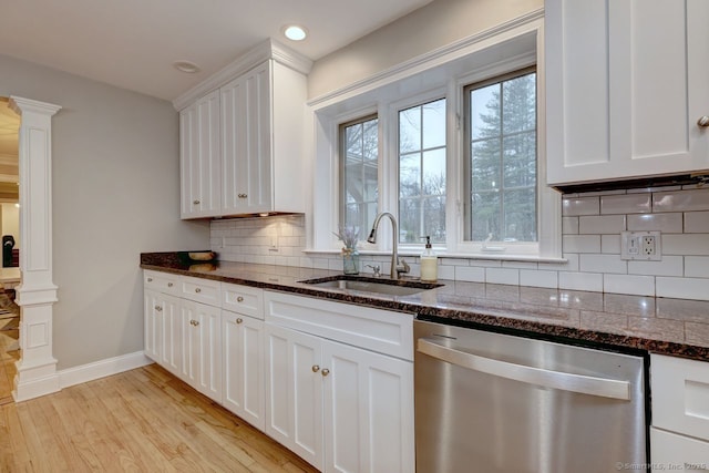 110 Far Mill Dr, Stratford, CT 06614 - kitchen featuring stainless steel dishwasher, light wood-style flooring, a sink, and decorative columns
