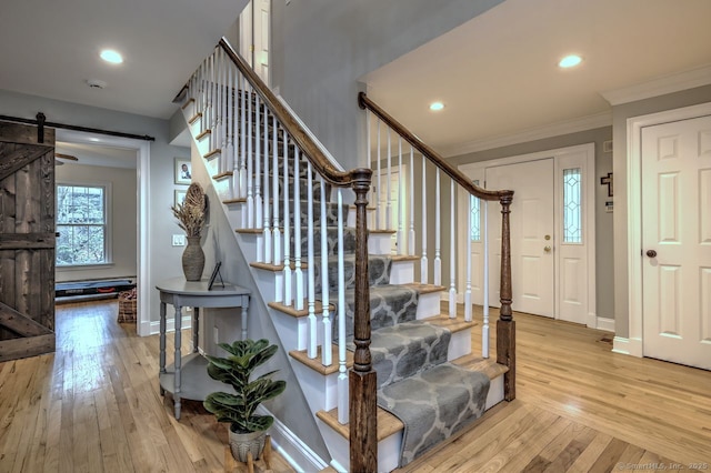 110 Far Mill Dr, Stratford, CT 06614 - stairway with crown molding, baseboards, a barn door, and hardwood / wood-style flooring