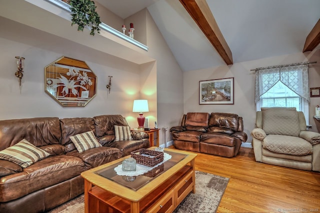 110 Far Mill Dr, Stratford, CT 06614 - living room with light wood finished floors, baseboards, and vaulted ceiling with beams