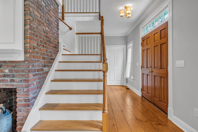 6 Ely Ln, Killingworth, CT 06419 - entryway with stairway, a chandelier, light wood-type flooring, baseboards, and brick wall