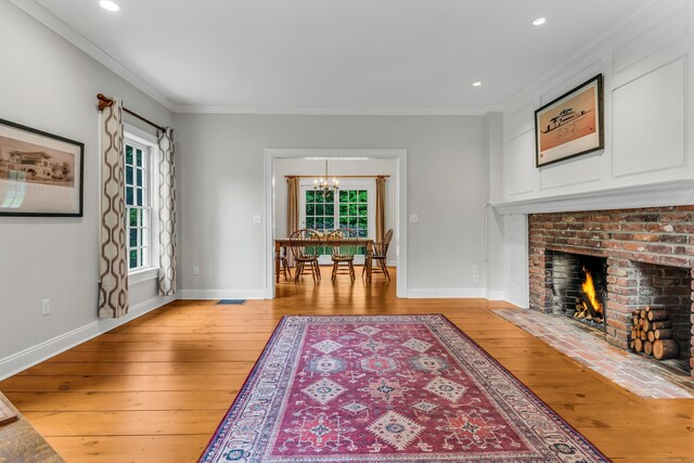 6 Ely Ln, Killingworth, CT 06419 - living area with light wood finished floors, ornamental molding, a chandelier, baseboards, and recessed lighting