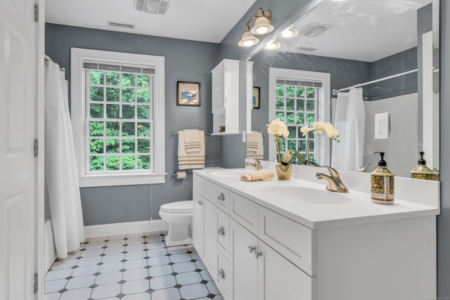 6 Ely Ln, Killingworth, CT 06419 - full bath featuring tile patterned floors, double vanity, curtained shower, toilet, and baseboards