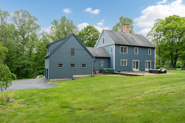 6 Ely Ln, Killingworth, CT 06419 - back of property featuring a chimney, a yard, a patio, and roof with shingles