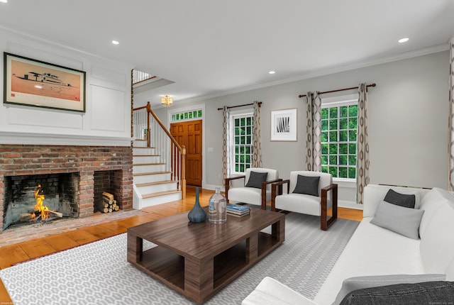 6 Ely Ln, Killingworth, CT 06419 - living area with light wood finished floors, stairs, ornamental molding, recessed lighting, and a brick fireplace